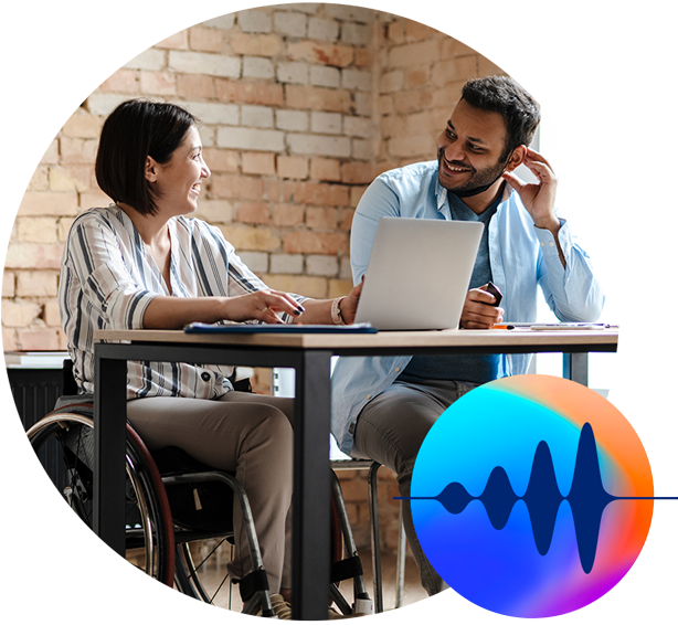 two office workings talking and smiling, one in a wheelchair