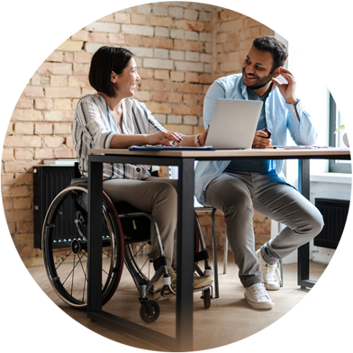 woman and man collaborating at table in office